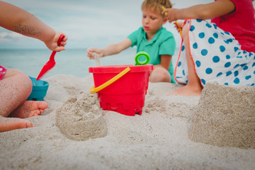 toys and kids -boy and girls- playing on beach