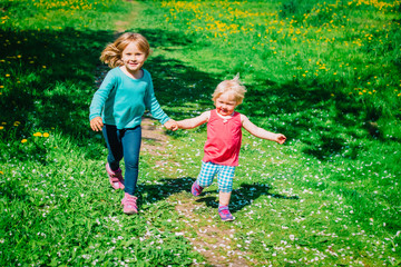 Fototapeta premium happy cute girls play run in spring nature