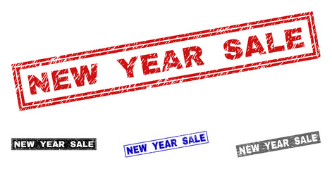 Grunge NEW YEAR SALE rectangle stamp seals isolated on a white background. Rectangular seals with grunge texture in red, blue, black and gray colors.
