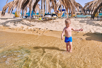 Toddler boy on beach