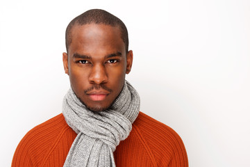 front portrait of handsome young black man with scarf posing against white background