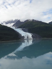 Glaciers within Glacier Bay National Park in Alaska. Glaciers coming over mountain peaks and...