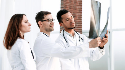 Group of doctors and nurses looking at X-ray