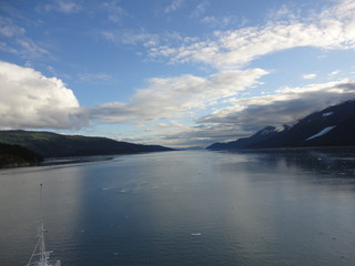 Passage in the Pacific Ocean between two mountain ranges. Calm peaceful waters flowing slowly under a cloudy sky.