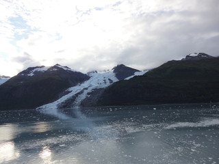 Glaciers within Glacier Bay National Park in Alaska. Glaciers coming over mountain peaks and sliding into the Pacific Ocean