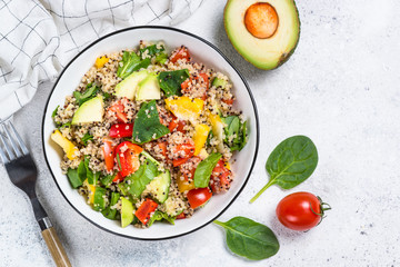 Quinoa salad with fresh vegetables on white.