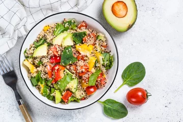 Fototapeten Quinoa salad with fresh vegetables on white. © nadianb