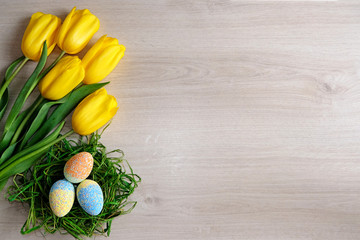 Easter background with Easter eggs and spring flowers.