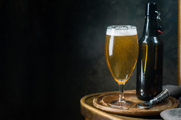 Glass beer on dark background with copy space