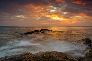 Beautiful seascape wave hit the rock at sunset in Thailand