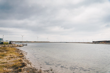 Fototapeta na wymiar The theme is net power generation and environmental protection. A number of wind blades, wind power in the Baltic Sea in Europe Denmark Copenhagen in winter