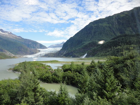 Mendenhall Glacier Juneau Alaska. Mendenhall Glacier flowing into Mendenhall Lake in between mountains with Nugget falls. Perfect tourist location