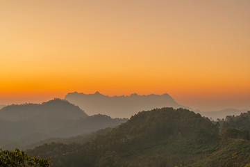 Naklejka na ściany i meble morning and sunrise on the winter season over the mountain layer at chingmai , thailand.