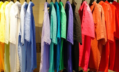 Colorful linen shirts hanging in a store