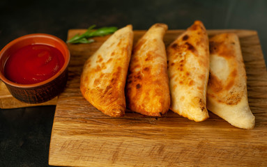 Latin American fried empanadas with tomato sauce.  Top view