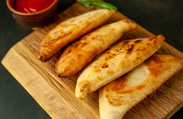Latin American fried empanadas with tomato sauce.  Top view