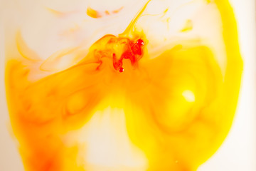 Orange oil paint on water abstract background.