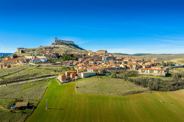 Atienza aerial panorama with blue sky of medieval ruined castle and town with city walls in Castille and Leon Spain