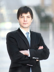 portrait of successful businessman on blurred background office.