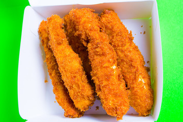 crusty cheese sticks fried in hot box lie in a box