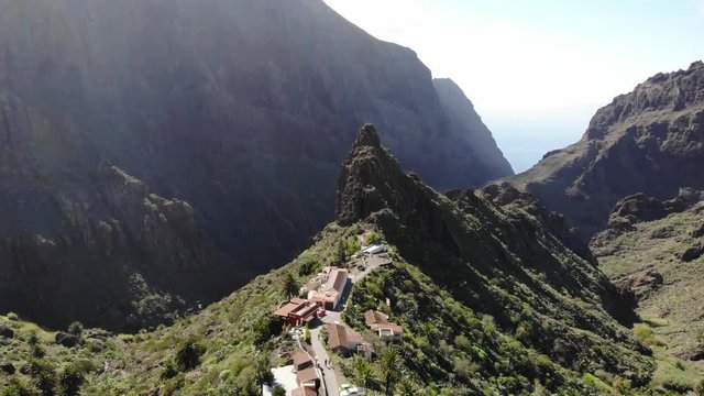 Flying over the Masca gorge Tenerife. Old village in the mountains. Famous tourist spot in the Masca gorge surrounded by volcanic mountains, beautiful nature