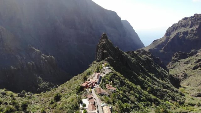 Flying over the Masca gorge Tenerife. Old village in the mountains. Famous tourist spot in the Masca gorge surrounded by volcanic mountains, beautiful nature
