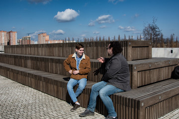 Two guys are relaxing in the park.