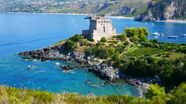 San Nicola Arcella, Calabria, Italy - September 6 2018: Dino island, Crawford tower (watchtower) and boats on Mediterranean sea (Tyrrhenian)