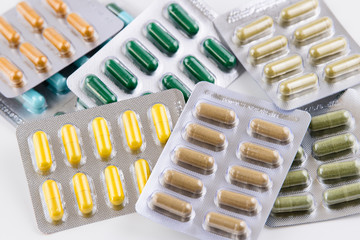 Closeup of herbal capsule in blister isolated on white background, medicine and drug concept