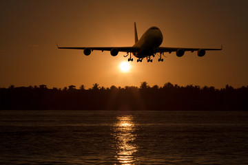 Fototapeta na wymiar 3D rendering of a commercial airplane landing / take off at sunset