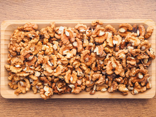 Obraz na płótnie Canvas Shelled walnuts in close-up on a wooden tray