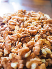 Shelled walnuts in close-up on a wooden tray