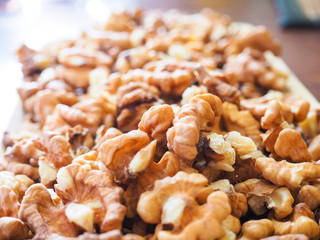 Shelled walnuts in close-up on a wooden tray