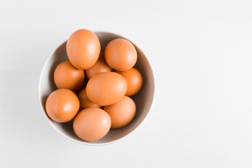 bowl full of fresh organic eggs isolated on white with copy space