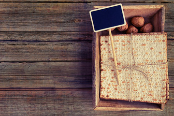 Pack of matzah or matza on a vintage wood background with copy space or text space. Top view or above view composition.