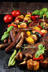 Assorted delicious grilled meat and skewer with vegetable on rustic table