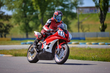 Motorcycle practice leaning into a fast corner on track