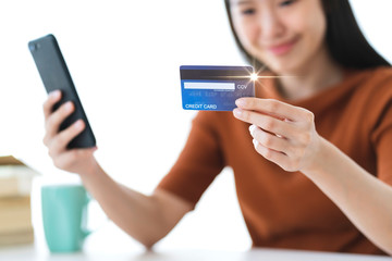 beautiful asian woman hand hold credit card and smartphone online shopping business ideas concept