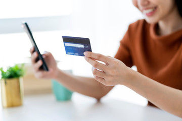 beautiful asian woman hand hold credit card and smartphone online shopping business ideas concept