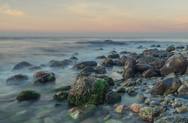 Nerja, Malaga, Andalusi, Spain - February 10, 2019: Playa del Molino, small stone beach with greenish rocks on the shore, Nerja, southern Spain