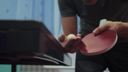 table tennis serve concept. slow motion video. blurred focus lifestyle on the grid. man playing training serve ball in table tennis the sport active