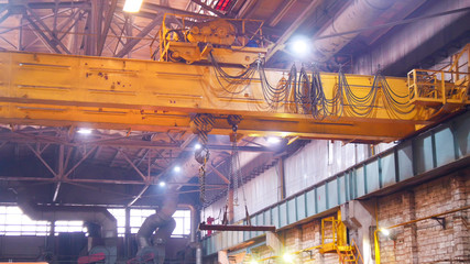 Industrial concept. A crane lifting a big iron beam