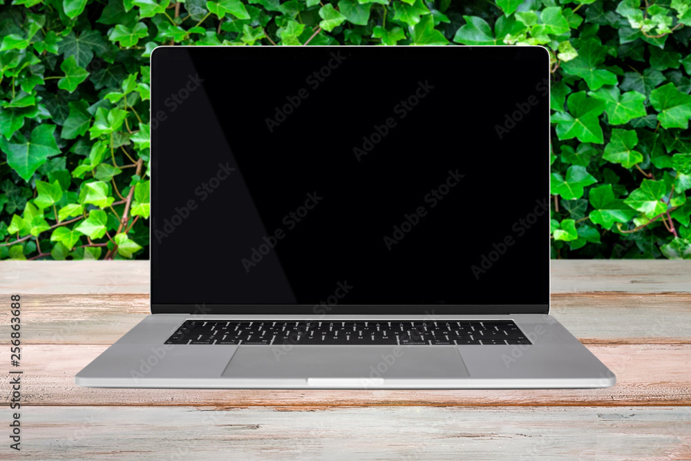 Wall mural green eco-friendly enviroment template - front view of a generic modern laptop with a black screen o