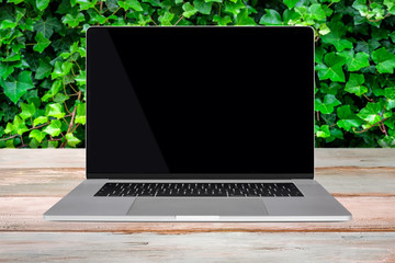Green Eco-Friendly enviroment template - front view of a generic modern laptop with a black screen...