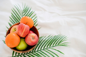 fresh fruit on wooden bowl on white bed morning healthy lifestyle