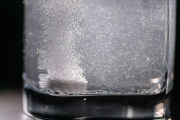 effervescent tablet in a glass of water