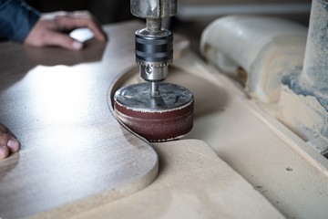 Man grind wood with a typewriter. Machine for grinding wood.