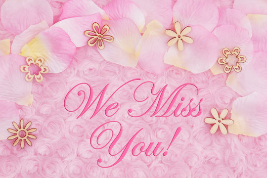 We Miss You message with a flower petals on pale pink rose plush fabric