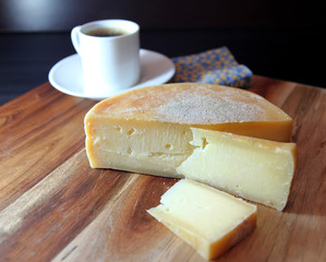 Brazilian cheese Queijo da Canastra. Fully cured cheese made from raw milk on wooden background.Selective focus.