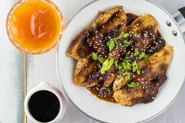 Homemade roasted chicken breast with apricot jam.
